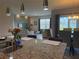Modern kitchen featuring granite counters and eat in counter, with an adjacent dining and living area at 306 Briar Patch Loop, Davenport, FL 33896
