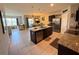 Open-concept kitchen with a granite island, modern appliances, and access to living area at 306 Briar Patch Loop, Davenport, FL 33896
