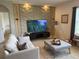 Modern living area enhanced by a unique accent wall, complemented by stylish decor and natural light at 306 Briar Patch Loop, Davenport, FL 33896