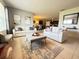 Inviting living room with neutral tones, comfortable seating, and an open flow to the dining area at 306 Briar Patch Loop, Davenport, FL 33896