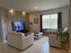 Relaxing living area with an accent wall and comfortable seating, perfect for unwinding and entertaining guests at 306 Briar Patch Loop, Davenport, FL 33896