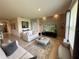 Comfortable living room featuring a textured accent wall, modern decor, and seamless access to other spaces at 306 Briar Patch Loop, Davenport, FL 33896
