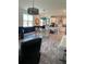 Open-concept living room with tiled flooring, a dining area, a kitchen island, and an adjacent sitting area at 3184 Songbird Cir, Harmony, FL 34773