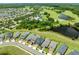 An aerial view showcases a scenic community near a lake, surrounded by lush greenery and a golf course at 3204 Oxbow Ct, St Cloud, FL 34773