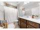 Well-lit bathroom features tile flooring, shower with curtain, and stylish dark wood vanity at 3204 Oxbow Ct, St Cloud, FL 34773