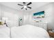 Bright bedroom with ceiling fan, TV, white dresser, large closet and decorative full length mirror at 3204 Oxbow Ct, St Cloud, FL 34773