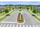 Elegant community entrance showcases lush landscaping, mature trees and well-maintained streets at 3204 Oxbow Ct, St Cloud, FL 34773