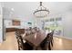 An elegant dining room with modern lighting, seamlessly connected to the kitchen and outdoor patio area at 3204 Oxbow Ct, St Cloud, FL 34773