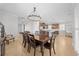 The dining room features a rustic wood table and a decorative chandelier, open to the kitchen at 3204 Oxbow Ct, St Cloud, FL 34773