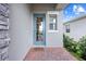 Inviting front door with brick entryway and a 'farmhouse' welcome mat at 3204 Oxbow Ct, St Cloud, FL 34773