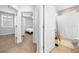 Hallway view shows entry to bedroom and bathroom, with neutral carpet and white trim at 3204 Oxbow Ct, St Cloud, FL 34773