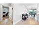Inviting hallway leading to an office space, complemented by an elegant side table and natural light at 3204 Oxbow Ct, St Cloud, FL 34773