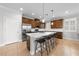 Spacious kitchen island with seating, white countertops, stainless steel appliances, and natural lighting at 3204 Oxbow Ct, St Cloud, FL 34773