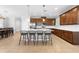 Stylish kitchen features island seating, modern lighting, stainless steel appliances, and ample cabinet space at 3204 Oxbow Ct, St Cloud, FL 34773