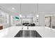 Bright, open-concept kitchen with a large island, stainless steel sink, and view of the living area at 3204 Oxbow Ct, St Cloud, FL 34773
