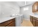 Laundry room with side-by-side washer and dryer, overhead rack and wood cabinets at 3204 Oxbow Ct, St Cloud, FL 34773
