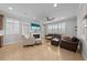 Comfortable living room featuring a fireplace, built-in shelving, tile floors, and lots of natural light at 3204 Oxbow Ct, St Cloud, FL 34773