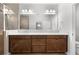 Bathroom with double vanity, wood cabinets, quartz countertops, and walk-in shower at 3204 Oxbow Ct, St Cloud, FL 34773