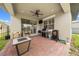 Covered brick patio with ceiling fan, grill, patio furniture, and outdoor TV at 3204 Oxbow Ct, St Cloud, FL 34773