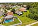Aerial view showing backyard, in-ground pool, the screened in porch, and surrounding neighborhood at 3217 Whooping Crane Run, Kissimmee, FL 34741