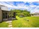 Expansive backyard featuring a screened porch, trampoline, and lush green lawn at 3217 Whooping Crane Run, Kissimmee, FL 34741
