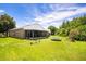 Large backyard with a screened porch, trampoline, and play equipment, perfect for outdoor activities at 3217 Whooping Crane Run, Kissimmee, FL 34741