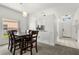 An open-concept dining area featuring modern lighting and views of the kitchen and entry at 3217 Whooping Crane Run, Kissimmee, FL 34741