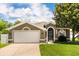 Charming single Gathering home with a well manicured lawn and a two car garage at 3217 Whooping Crane Run, Kissimmee, FL 34741