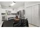 A view of the sink, stainless appliances, and kitchen adjacent to the dining area at 3217 Whooping Crane Run, Kissimmee, FL 34741