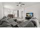 Spacious living room with a large sectional sofa, modern TV, and ceiling fan at 3217 Whooping Crane Run, Kissimmee, FL 34741
