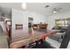 Open-concept space: dining table leads to cozy living room featuring ceiling fan and sectional at 3217 Whooping Crane Run, Kissimmee, FL 34741