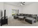 Cozy living room with plush sectional sofa and sliding glass doors to outdoor patio at 3217 Whooping Crane Run, Kissimmee, FL 34741