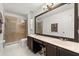 The main bathroom features double sinks, a large mirror, a tiled shower, and tile floors at 3217 Whooping Crane Run, Kissimmee, FL 34741