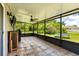 This is a screened patio with a ceiling fan, tile flooring, and views of the backyard at 3217 Whooping Crane Run, Kissimmee, FL 34741