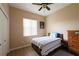Neutral bedroom with a ceiling fan, a window, a closet, and a queen bed at 406 Cinnamon Dr, Kissimmee, FL 34759