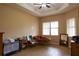 Relaxing bedroom with a tray ceiling, wood floors, and plenty of natural light at 406 Cinnamon Dr, Kissimmee, FL 34759