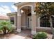 Inviting front porch with a decorative door, brick walkway, and mature landscaping at 406 Cinnamon Dr, Kissimmee, FL 34759
