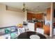 Open kitchen and dining area with wood cabinets, perfect for cooking and entertaining guests at 406 Cinnamon Dr, Kissimmee, FL 34759