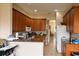 Well-equipped kitchen boasts wood cabinets, stainless appliances, granite countertops, and ample counter space at 406 Cinnamon Dr, Kissimmee, FL 34759