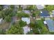 Overhead view of a cozy home featuring a metal roof and private, tree-lined yard with mature plantings at 441 Kentia Rd, Casselberry, FL 32707