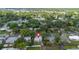 A charming home surrounded by verdant trees and colorful landscaping, captured from an appealing aerial perspective at 441 Kentia Rd, Casselberry, FL 32707