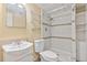 Cozy bathroom featuring tiled shower, toilet, sink and mirror at 441 Kentia Rd, Casselberry, FL 32707