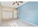 A bedroom with blue accent wall, closet and ceiling fan at 441 Kentia Rd, Casselberry, FL 32707