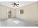 A bedroom featuring a ceiling fan and a door leading to outside at 441 Kentia Rd, Casselberry, FL 32707