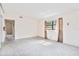 A living room with a large window for natural light and a glimpse into an adjacent room at 441 Kentia Rd, Casselberry, FL 32707