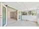 Enclosed patio featuring view of back yard through double doors leading inside at 441 Kentia Rd, Casselberry, FL 32707