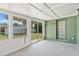 Enclosed patio with green walls and sliding glass doors leading to the backyard at 441 Kentia Rd, Casselberry, FL 32707