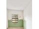 A room showing a window with green lower wall paint, and unfinished upper wall paint at 441 Kentia Rd, Casselberry, FL 32707