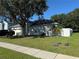 Well-maintained home with an attached garage, lush green lawn, and a privacy fence around the perimeter at 478 Acacia Tree Way, Kissimmee, FL 34758