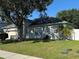 Inviting single-story home with a manicured lawn, attached garage, and mature landscaping offering shade at 478 Acacia Tree Way, Kissimmee, FL 34758